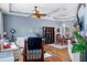 Inviting living room featuring tray ceilings, ceiling fan, modern furnishings, and bright, neutral paint tones at 18026 Macy Rd, Weeki Wachee, FL 34614