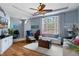 Open concept living room with a ceiling fan, neutral paint tones, and tile and wood flooring at 18026 Macy Rd, Weeki Wachee, FL 34614