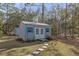 Charming shed with white trim and a stepping stone path, perfect for storage or a hobby space at 18026 Macy Rd, Weeki Wachee, FL 34614