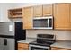 View of kitchen, showcasing stainless steel appliances and wood cabinets at 18327 Bridle Club Dr # 18327, Tampa, FL 33647