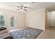 Living room featuring a ceiling fan and access to balcony at 18327 Bridle Club Dr # 18327, Tampa, FL 33647