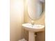 Clean bathroom with pedestal sink and oval mirror at 18840 Parapet Pl, Land O Lakes, FL 34638