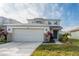 Two-story house with attached garage and landscaping at 18840 Parapet Pl, Land O Lakes, FL 34638