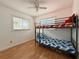 Bright bedroom with bunk beds and hardwood floors at 2526 44Th S St, St Petersburg, FL 33711