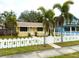 Cute yellow house with white picket fence and palm trees at 2526 44Th S St, St Petersburg, FL 33711