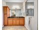 Bathroom featuring granite countertop and wood cabinets at 2659 Keystone Springs Rd, Tarpon Springs, FL 34688