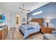 Main bedroom with wood floors, ceiling fan, and ensuite bathroom at 2659 Keystone Springs Rd, Tarpon Springs, FL 34688