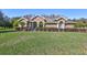 Beautiful home with a manicured lawn and lush landscaping at 2659 Keystone Springs Rd, Tarpon Springs, FL 34688