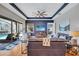 Living room with hardwood floors, leather sofas, and views of the pool at 2659 Keystone Springs Rd, Tarpon Springs, FL 34688