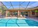 Inviting kidney-shaped pool with screened enclosure at 2659 Keystone Springs Rd, Tarpon Springs, FL 34688