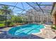 Inviting kidney-shaped pool with screened enclosure at 2659 Keystone Springs Rd, Tarpon Springs, FL 34688