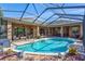 Inviting kidney-shaped pool with screened enclosure at 2659 Keystone Springs Rd, Tarpon Springs, FL 34688