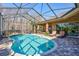 Inviting kidney-shaped pool with screened enclosure at 2659 Keystone Springs Rd, Tarpon Springs, FL 34688