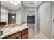 Bathroom with granite countertop, double sinks, and view of bedroom at 2733 Glenview Dr, Land O Lakes, FL 34639