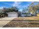 Gray house with white garage door and walkway leading to the entrance at 2733 Glenview Dr, Land O Lakes, FL 34639