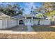 House with gray exterior, white door, two-car garage, and a landscaped front yard at 2733 Glenview Dr, Land O Lakes, FL 34639