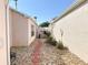 Charming backyard walkway with stone pavers leading to a screened-in lanai area at 286 Royal Palm Way, Spring Hill, FL 34608