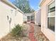 Charming backyard walkway with stone pavers leading to a screened-in lanai area at 286 Royal Palm Way, Spring Hill, FL 34608