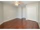 Bedroom with hardwood floors, ceiling fan and light, and double door closet for ample storage space at 286 Royal Palm Way, Spring Hill, FL 34608