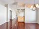 Dining room showcasing hardwood floors, chandelier and arched doorway at 286 Royal Palm Way, Spring Hill, FL 34608