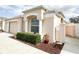 Close-up of a stucco home showcasing architectural details, manicured hedges, and a well-maintained facade at 286 Royal Palm Way, Spring Hill, FL 34608