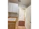 Bright laundry room with white cabinets, a utility sink, and neutral wall paint at 286 Royal Palm Way, Spring Hill, FL 34608