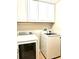 Bright laundry room with white cabinets and Samsung washer/dryer set at 286 Royal Palm Way, Spring Hill, FL 34608