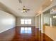 Bright and spacious living room featuring hardwood floors and a modern ceiling fan at 286 Royal Palm Way, Spring Hill, FL 34608