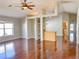 Spacious living room featuring hardwood floors, built-in shelving, and a view into the adjacent kitchen at 286 Royal Palm Way, Spring Hill, FL 34608