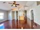 Open-concept living room showcasing hardwood floors, a ceiling fan, built-in features, and natural light at 286 Royal Palm Way, Spring Hill, FL 34608