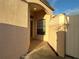 Side entrance with arched entryway and white fence at 286 Royal Palm Way, Spring Hill, FL 34608