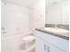 Clean bathroom, white tile, single sink vanity, and bathtub at 30822 Veridian Way, Wesley Chapel, FL 33543