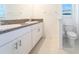 Bathroom with double vanity and granite countertop at 30822 Veridian Way, Wesley Chapel, FL 33543