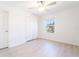 Bright bedroom with wood-look floors, double closet, and ceiling fan at 30822 Veridian Way, Wesley Chapel, FL 33543