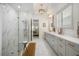 Spa-like bathroom with marble shower, double vanity, and modern fixtures at 33843 Galley Way, Wesley Chapel, FL 33543