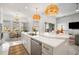 Bright kitchen with stainless steel appliances, island, and light colored countertops at 33843 Galley Way, Wesley Chapel, FL 33543