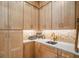 Light wood kitchenette with a herringbone backsplash and gold accents at 33843 Galley Way, Wesley Chapel, FL 33543