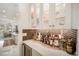 Wet bar with glass-front cabinets and a marble countertop at 33843 Galley Way, Wesley Chapel, FL 33543