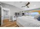 Bright main bedroom with king bed, wood floors, and access to a private balcony at 370 8Th N Ave # 7, Tierra Verde, FL 33715