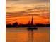 Silhouette of a sailboat gliding on the water with a vibrant sunset backdrop at 370 8Th N Ave # 7, Tierra Verde, FL 33715