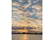 Stunning sunset view with scattered clouds over the water, reflecting golden light at 370 8Th N Ave # 7, Tierra Verde, FL 33715