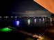 Night view of boats decorated with lights on the water near a long wooden dock and waterfront community at 370 8Th N Ave # 7, Tierra Verde, FL 33715