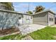 Backyard view of home with concrete patio at 4724 W Lawn Ave, Tampa, FL 33611