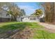 Backyard view of home with grassy area and patio at 4724 W Lawn Ave, Tampa, FL 33611