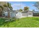 View of home from backyard with concrete patio at 4724 W Lawn Ave, Tampa, FL 33611