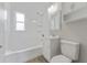 Clean bathroom with white fixtures and wood-look floors at 4724 W Lawn Ave, Tampa, FL 33611