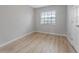 Bright bedroom with wood-look floors and window at 4724 W Lawn Ave, Tampa, FL 33611