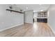 Open concept dining area with dark cabinets and wood-look floors at 4724 W Lawn Ave, Tampa, FL 33611