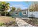 Gray house with teal door and small front yard at 4724 W Lawn Ave, Tampa, FL 33611