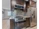 Kitchen with stainless steel appliances and a metallic backsplash at 4724 W Lawn Ave, Tampa, FL 33611